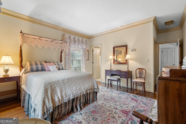 bedroom featuring baseboards, a textured ceiling, wood finished floors, and ornamental molding