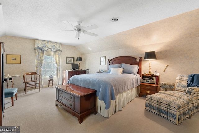 bedroom with visible vents, a textured ceiling, lofted ceiling, light colored carpet, and ceiling fan