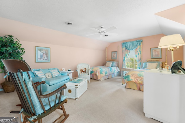 bedroom featuring visible vents, ceiling fan, lofted ceiling, carpet flooring, and a textured ceiling