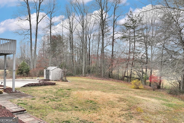 view of yard with an outbuilding, a storage shed, and a deck