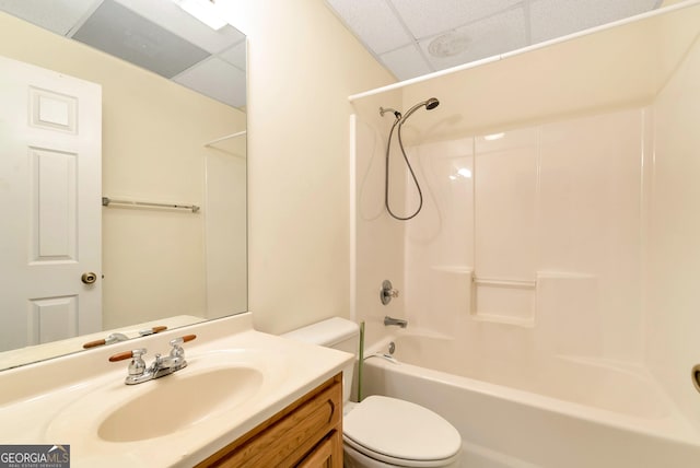 bathroom featuring tub / shower combination, a paneled ceiling, toilet, and vanity