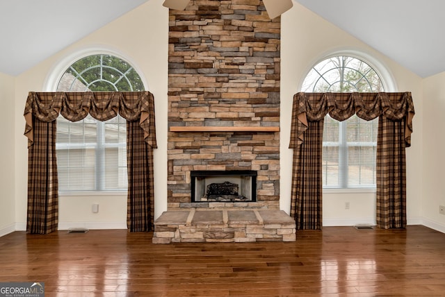 unfurnished living room featuring visible vents, hardwood / wood-style flooring, and vaulted ceiling