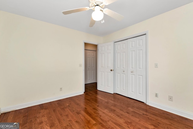 unfurnished bedroom featuring a closet, ceiling fan, baseboards, and wood finished floors