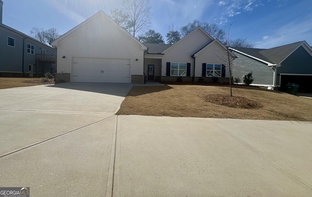 ranch-style house with brick siding, an attached garage, and driveway