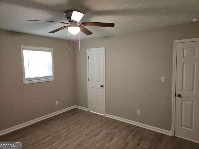 147 Mildred Ct, Dallas, GA 30157 - unfurnished bedroom featuring dark wood-style floors and a ceiling fan