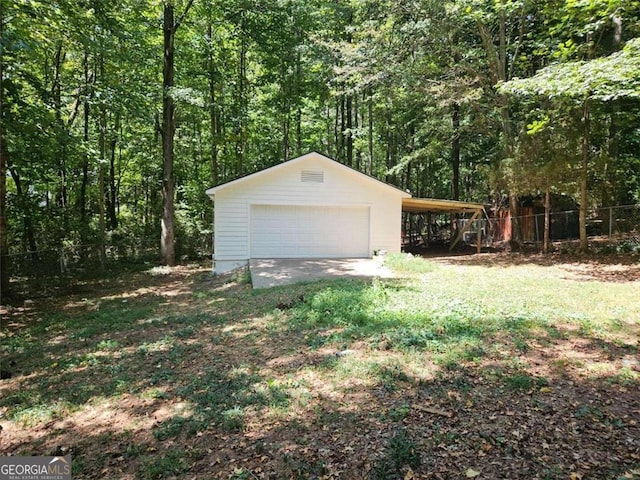 147 Mildred Ct, Dallas, GA 30157 - garage featuring a detached garage and a wooded view