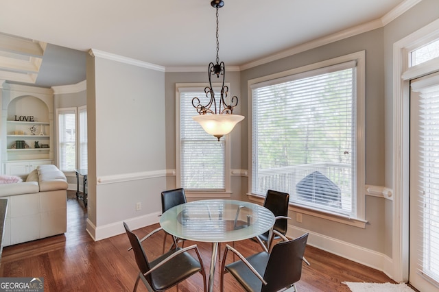 dining space with a healthy amount of sunlight, ornamental molding, and wood finished floors