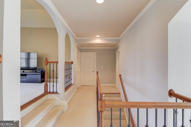 corridor featuring recessed lighting, arched walkways, carpet, crown molding, and baseboards