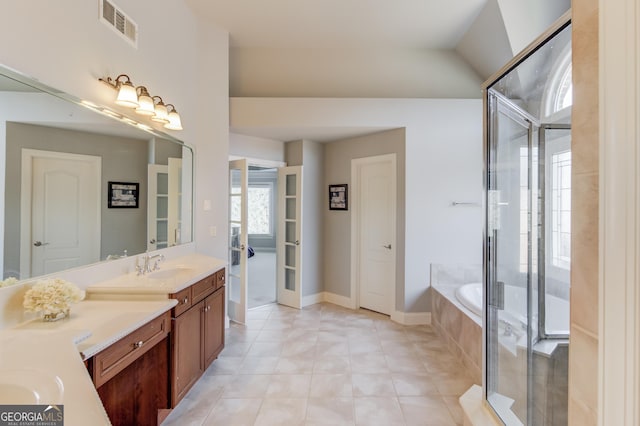 bathroom with visible vents, an enclosed shower, a garden tub, tile patterned flooring, and vanity