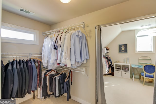 walk in closet featuring visible vents and carpet floors