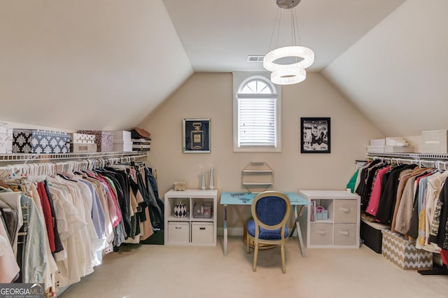 walk in closet featuring lofted ceiling, carpet, and visible vents