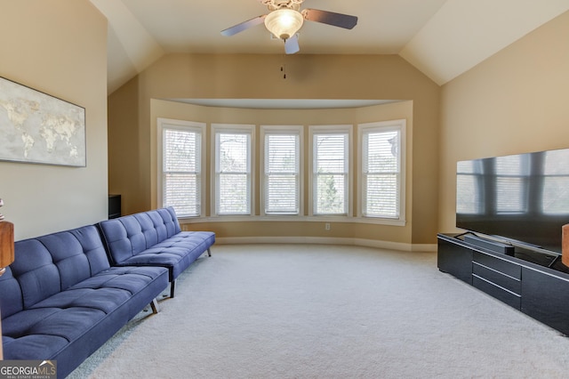 carpeted living area with ceiling fan, baseboards, a healthy amount of sunlight, and lofted ceiling