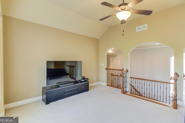 living area featuring visible vents, baseboards, lofted ceiling, an upstairs landing, and carpet flooring