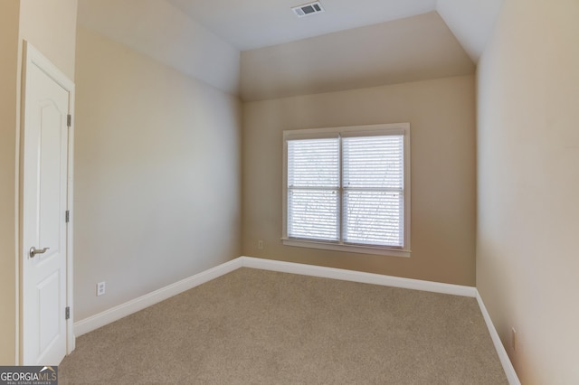 unfurnished room featuring vaulted ceiling, visible vents, baseboards, and carpet floors