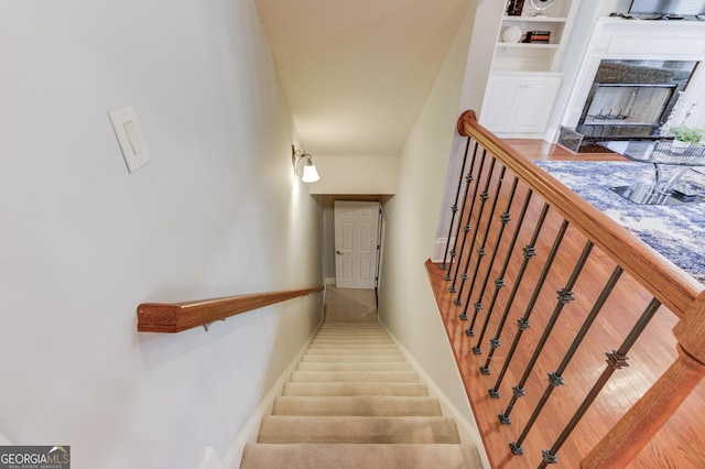 stairs featuring a premium fireplace