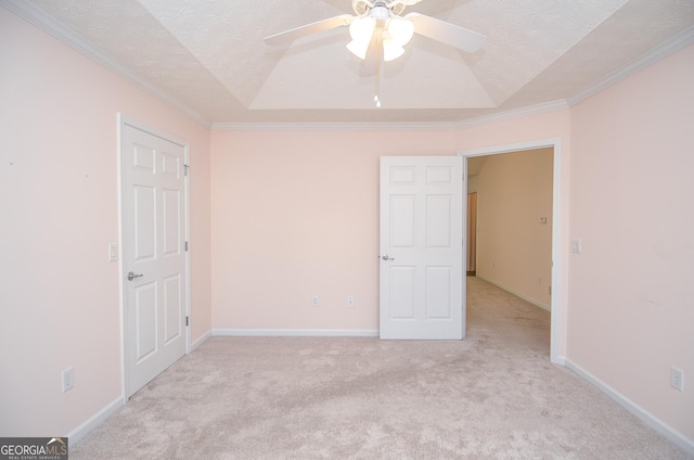 unfurnished bedroom with a textured ceiling, light colored carpet, ornamental molding, and lofted ceiling