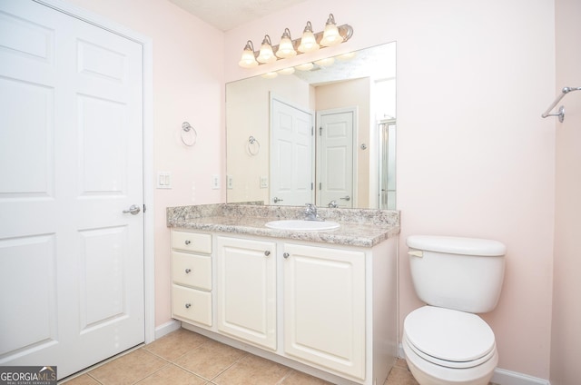 full bathroom featuring vanity, tile patterned floors, toilet, and baseboards