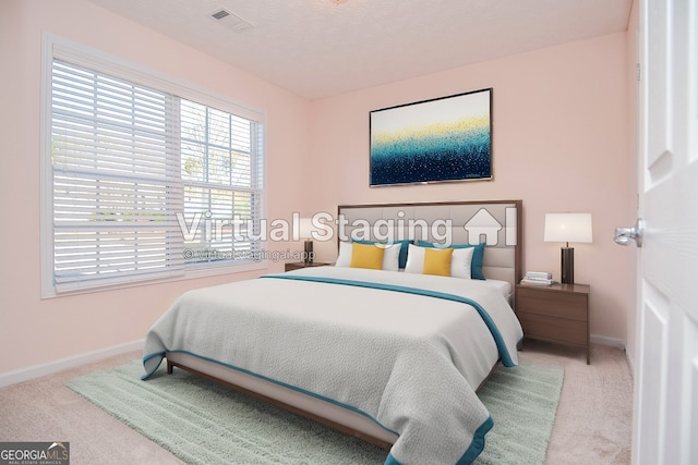 bedroom featuring carpet flooring, baseboards, and visible vents