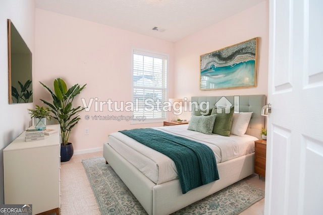 bedroom with baseboards and visible vents