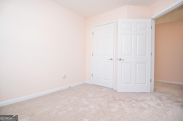 unfurnished bedroom with baseboards and carpet floors