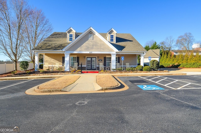 view of building exterior featuring fence and uncovered parking