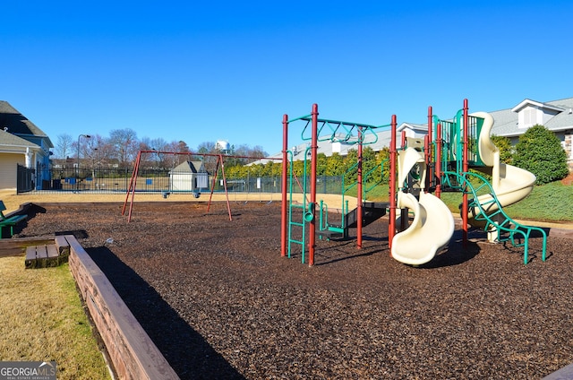 community jungle gym featuring fence