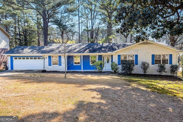 ranch-style house featuring a front lawn, brick siding, a garage, and driveway