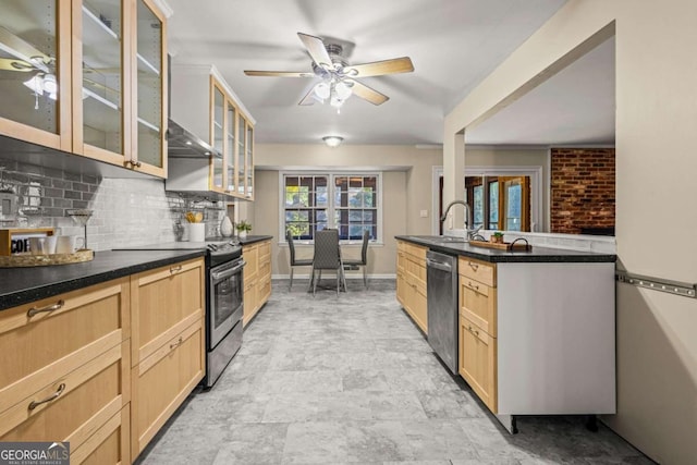 kitchen featuring light brown cabinets, tasteful backsplash, appliances with stainless steel finishes, glass insert cabinets, and ceiling fan