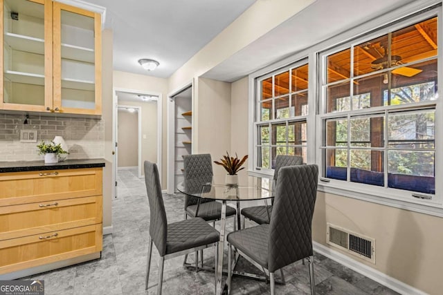 dining room featuring visible vents and baseboards