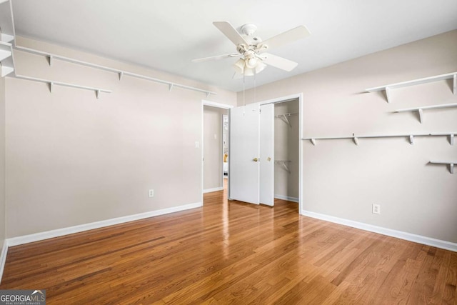 unfurnished bedroom with baseboards, wood finished floors, and a ceiling fan