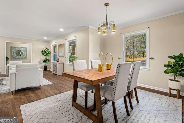 dining space with crown molding, baseboards, dark wood finished floors, recessed lighting, and an inviting chandelier