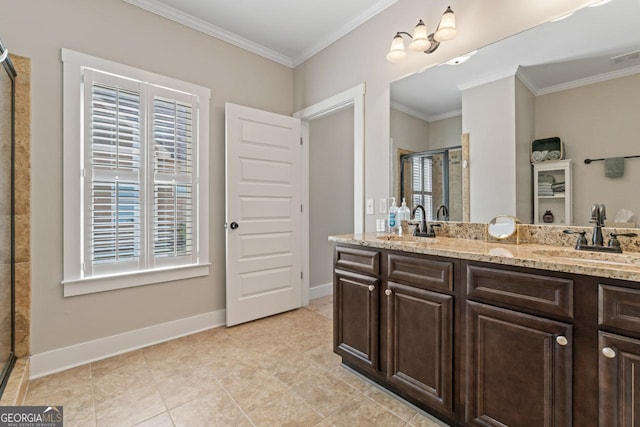 bathroom with crown molding, baseboards, a stall shower, and a sink