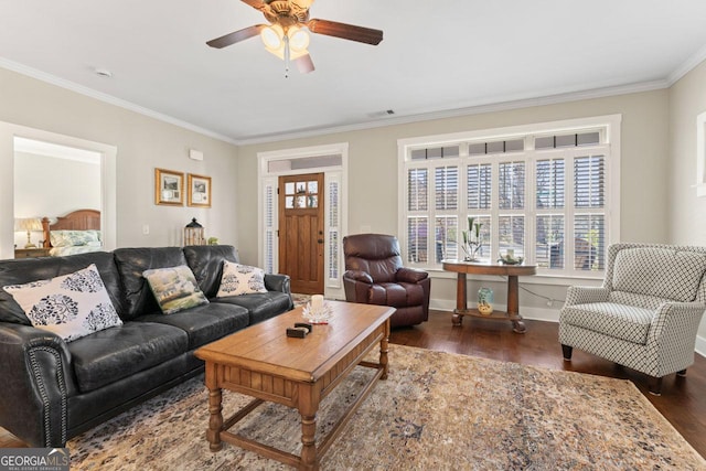 living area featuring visible vents, crown molding, baseboards, ceiling fan, and dark wood-style flooring