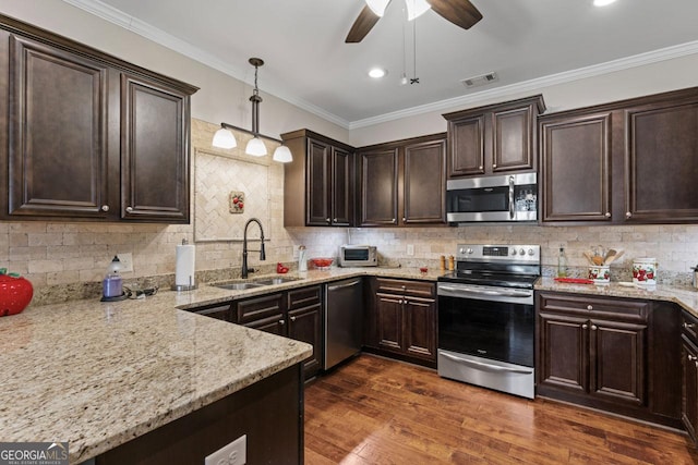 kitchen with dark wood-style floors, visible vents, a sink, appliances with stainless steel finishes, and crown molding