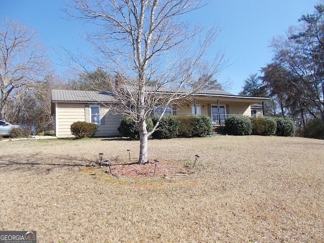 single story home with covered porch and a front yard