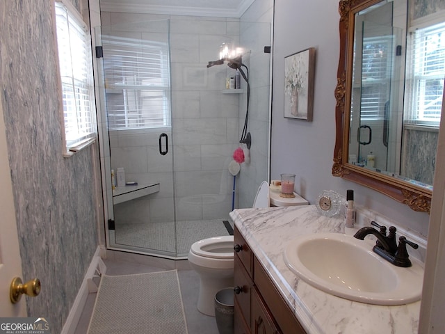 bathroom with vanity, toilet, ornamental molding, and a shower stall