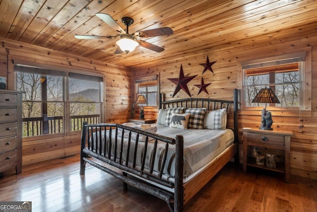 bedroom featuring multiple windows, wooden ceiling, and wood finished floors