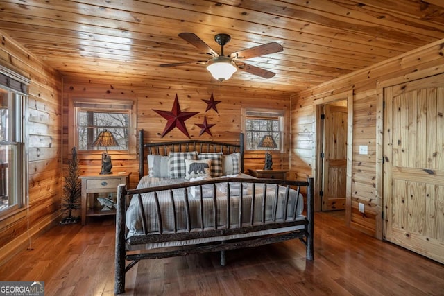 bedroom with wood walls, wooden ceiling, and hardwood / wood-style floors