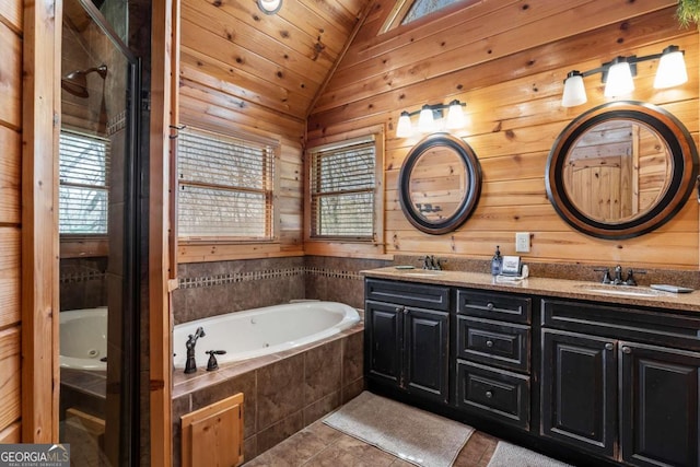 bathroom featuring double vanity, lofted ceiling, plenty of natural light, and a sink