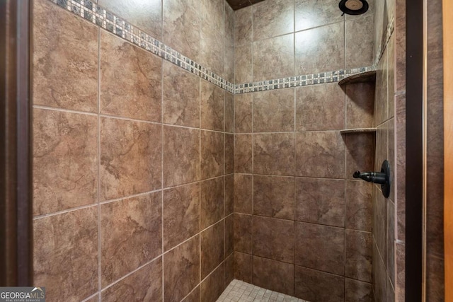 bathroom with a tile shower