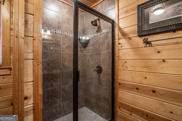 full bathroom with wood walls and a shower stall