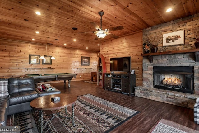 living area with wood finished floors, a fireplace, pool table, wood ceiling, and ceiling fan