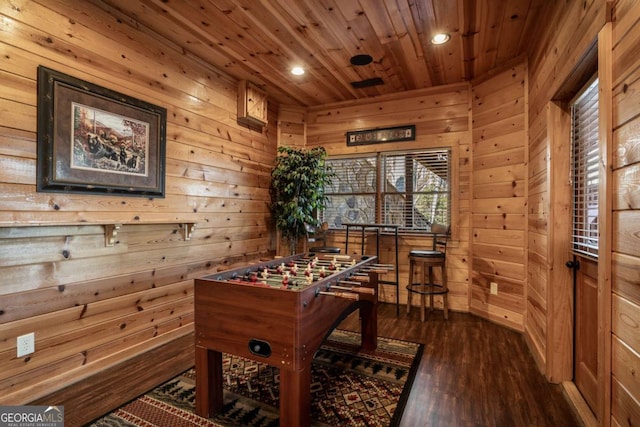 playroom with recessed lighting, dark wood-type flooring, wood ceiling, and wood walls