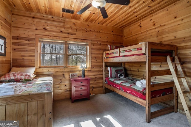 carpeted bedroom with a sauna, wooden walls, and wood ceiling