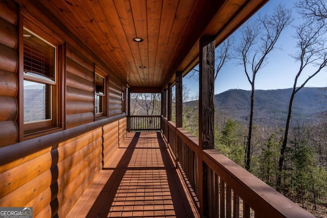 deck featuring covered porch and a mountain view