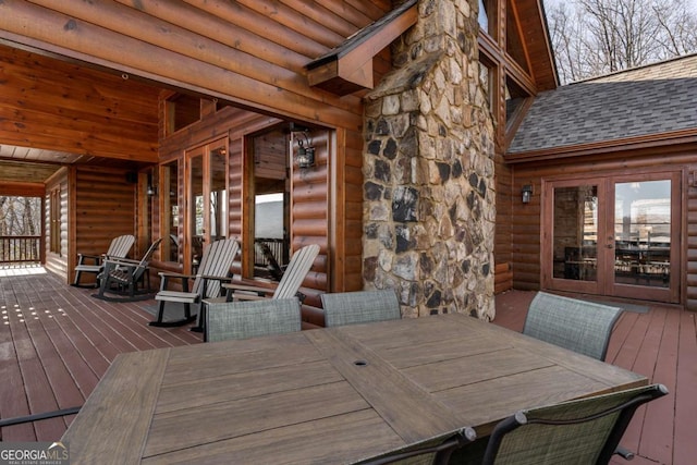 wooden deck with outdoor dining space and french doors