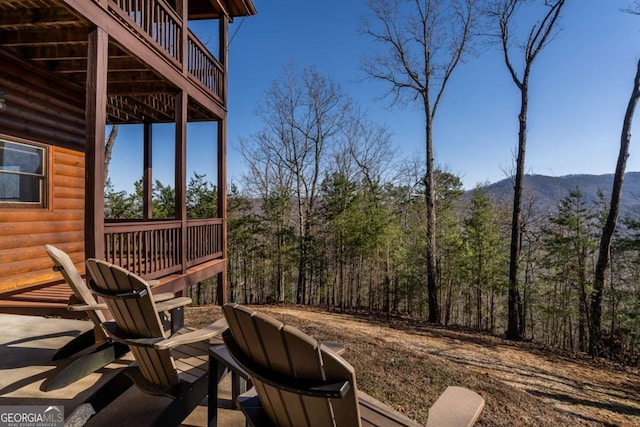 view of patio featuring a mountain view and a wooded view