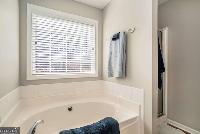 full bath with a garden tub and a shower stall