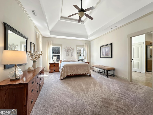 carpeted bedroom with a raised ceiling, crown molding, visible vents, and ceiling fan