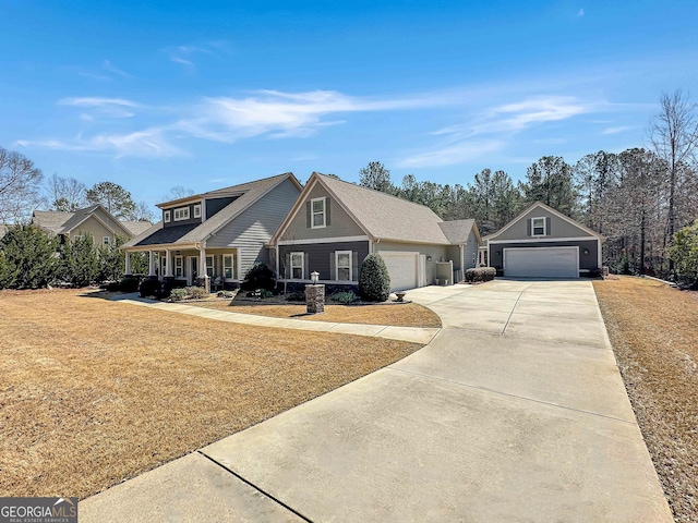 view of front facade with driveway, a front lawn, and a garage